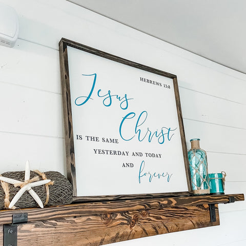 Farmhouse style wood sign with Hebrews 13:8 scripture painted on it.