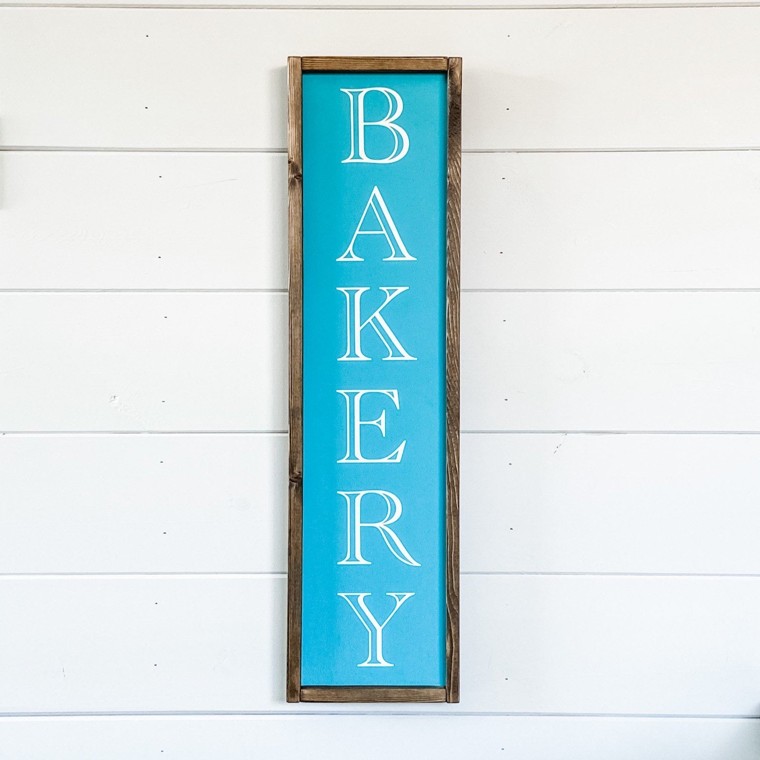 Handcrafted wood sign with the word "Bakery" painted on it