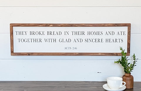 Farmhouse style wood sign with Acts 2:46 scripture painted on it.