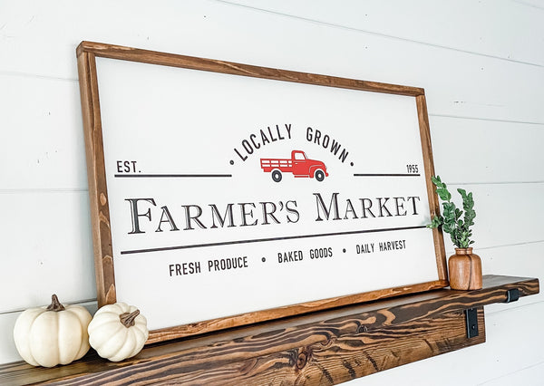 Farmer's Market wood sign with a red truck