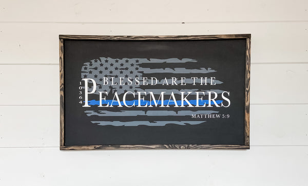 Farmhouse style wood sign with Matthew 5:9 scripture painted on it