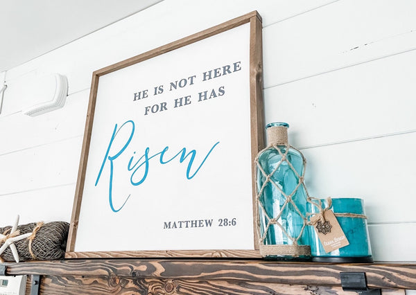 Farmhouse style wood sign with Matthew 28:6 scripture painted on it.